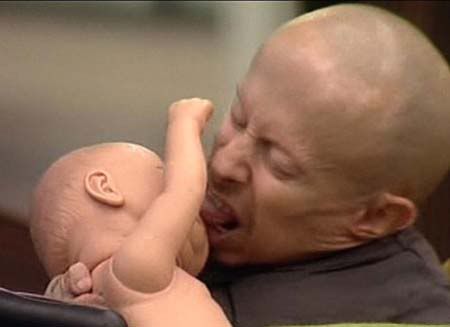 verne-troyer-kissing-a-baby-doll.jpg